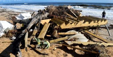 a pile of various debris on a beach.