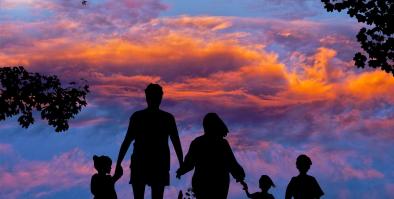 Family silhouette with colorful sky