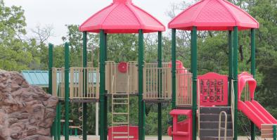 Children's playground with ladders, slide, and a climbing wall