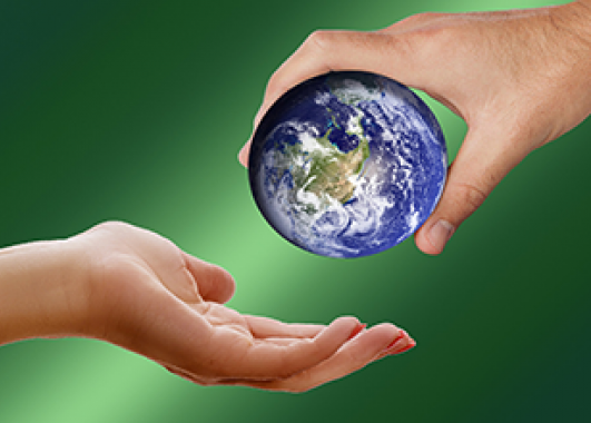 a person's hand passing a small sized Earth to another person's hand. 