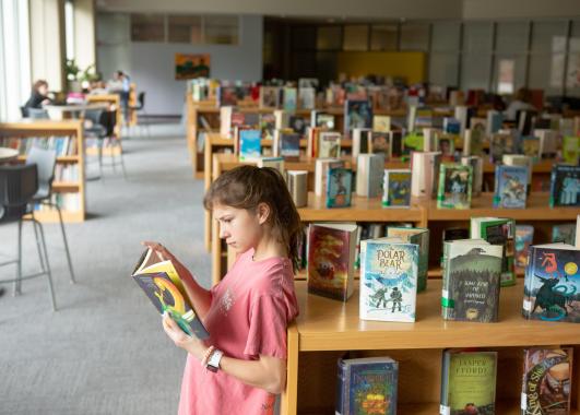 Student reading in a library