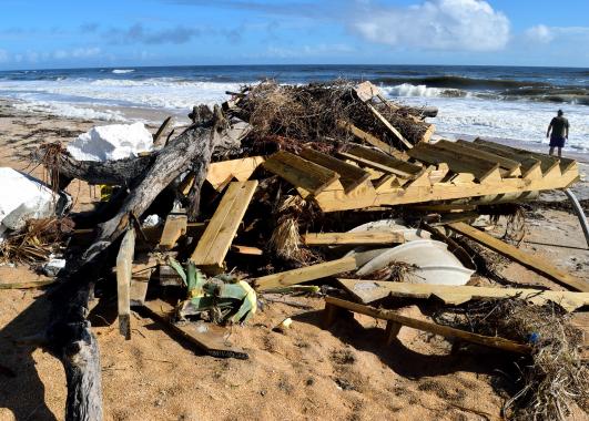 a pile of various debris on a beach.