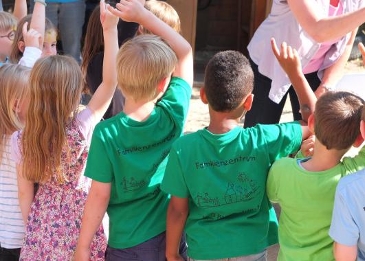 children raising their hands