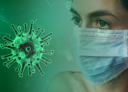 This is an image of a person, wearing a surgical mask, facing a coronavirus.