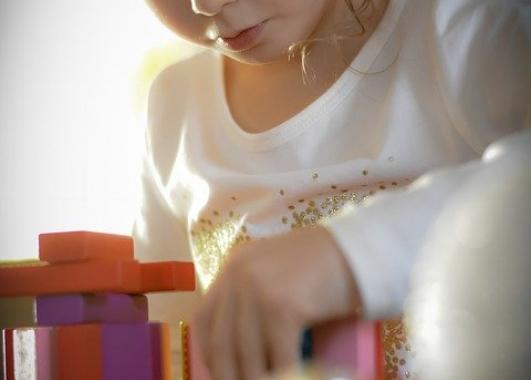 A child focusing on building with blocks